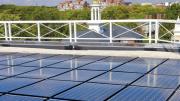Harvard is already trying many green initiatives; it will need to do much more to meet its new greenhouse-gas emissions goal. Above: solar panels on the roof of the Business School’s Shad Hall.