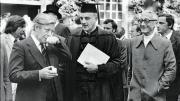 President Derek Bok and honorand Jacques-Yves Cousteau observe West Germany’s chancellor, honorand Helmut Schmidt, pause for a pinch of snuff (1979).