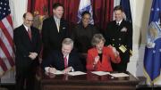 Done deal. U.S. Secretary of the Navy Ray Mabus and President Drew Faust sign the ROTC agreement as (left to right) Vice President and General Counsel Robert Iuliano, Assistant Secretary of the Navy Juan M. Garcia III, Dean of Harvard College Evelynn Hammonds, and Vice Admiral Mark E. Ferguson III look on.