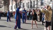 A female Lampoon member wearing a gold sequined dress passes the ball to a teammate.