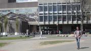 6. Preconstruction: the main pedestrian crossroads, seen from Harvard Yard looking north toward the main mass of the Science Center; the bamboo planters then in place, to the left, will be replaced with a much larger, continuous, permanent planting of mixed species, to form a shaded grove.
