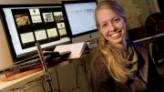 Historian Jo Guldi in her office at the Society of Fellows. She uses visualizations such as those shown behind her to aid her research.