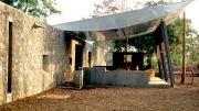 This country house, built for a filmmaker, includes a portico that becomes communal space when the owners aren't using it.