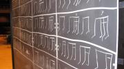“School of THUD” also involved rhythms tapped with chalk on a chalkboard. The musicians draw up the score as they play, and play the rhythms forward and backward.