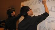 At a rehearsal, twins Seungsoo Kim ’13 and Seungjun Kim ’13 practice a number that involves tapping out sounds with markers on a whiteboard. 