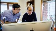 Peng Yi and Douglas Melton, looking at images from their study.
