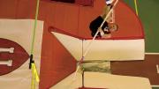 Weiler on his way up to clear the bar (green, at left). Note the bend in his pole, far below. The orange foam pads cushion landings. 