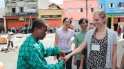 During a tour of a shantytown in the heart of São Paulo, a resident feigns a wedding proposal to HSPH’s Sarah MacDonald, as University of São Paulo's Ana Carolina Navarrete (left) and HSPH's Panji Hadisoemarto look on.