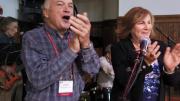 Chris Mortenson and his wife, Winnie, applaud an open-mic music session