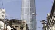 Complete with heliport, the Bitexco Tower rises over traditional Ho Chi Minh City. 