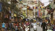 Hanoi&rsquo;s streets (in 2007, above) are now full of motorcycles and scooters, and shop shelves are no longer bare.