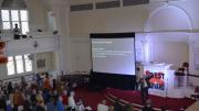 First Parish's Rev. Fred Small, M.Div. ’99, leads the crowd in a song about divestment.