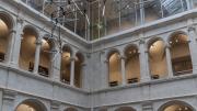 A chrome-plated triangle dangles from the end of each painted steel bar, their weight carefully distributed to achieve equilibrium. The joints of the sculpture allow it to rotate freely in the air.