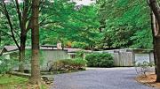 This low-lying, woods-bound home is located in the Peacock Farm enclave.