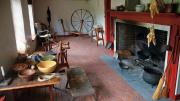 Open hearth, spinning wheel, and other elements in the colonial-era Sylvanus Brown House in Pawtucket, Rhode Island