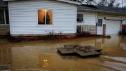 Centreville resident Earlie Fuse looks out his home window at the flooding that his filled his yard.