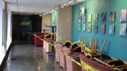 A hallway in Quincy House, with chairs cordoned off limits against the wall