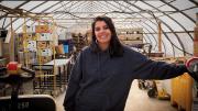 Usha Thakrar standing in the greenhouse production center at Stonefield Farm