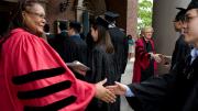 Harvard CoDean of Harvard College Evelynn M. Hammonds greets a graduating senior. In the background is Lowell House co-master Dorothy Austin, Sedgwick associate minister in the Memorial Church and University Chaplain.