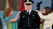 Second lieutenant Christopher Higgins has his bars pinned on by his mother and sister.