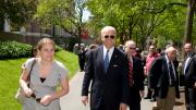 Biden walks with his former deputy press secretary, AnnMarie Tomasini, who is now director for intergovernmental relations in Harvard's office of public affairs and communications.