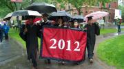 Class marshal Oluwadamilola “Dammy” Akinfenwa, class treasurer Marta Bralic, and class marshals Athena Lao and Matthew DaSilva carry the seniors’ banner.