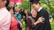 Alvin Siu ’13 hugs his grandmother. To the left are his mother (in black) and two aunts.