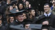 After a traditional doffing of caps to John Harvard, seniors process to Memorial Church.