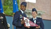 The force is with the U.S. Air Force as General McDew receives a Harvard banner from Second Lieutenant Madison Coveno.