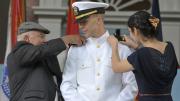 Ensign Christopher Curtis receives his new insignia.