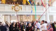 Graduating students carry streamers into Memorial Church.
