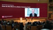 A plenary session at the Harvard Climate Symposium featured Jeremy Grantham, Janet McCabe, Gillian Tett (moderating), and via video link, Mark Carney.
