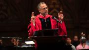 Adam Falk delivering his talk in academic robes