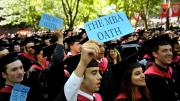 Business School candidates Teal Carlock, Umaimah Mendhro, and Dominic Dragisich promote the new M.B.A. oath.