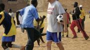 Nick Gates ’91, who founded Coaches Across Continents, works with coaches (above) and youths (at right) in Tanzania in 2009. 