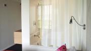 Glass wall separates bathroom from bedroom in new Kripalu dorm