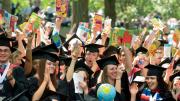 Still bullish on books: School of Education graduates celebrate their degrees. The picture books they carry are donated later; this year, half the books went to the Make-A-Wish Foundation, and half to the Reach Out and Read program at Children's Hospital Boston.