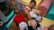 This teenager regularly hurries from  his job to a local day-care center to  spend time with his son in his new role  as a father.