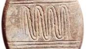 This incised and polished pebble from Netiv Hagdud, 11,000 years old, displays a meandering pattern between parallel sets of horizontal lines that perhaps represents a river.