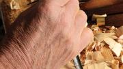 Esterly attacking limewood with the two-fisted technique of woodcarving