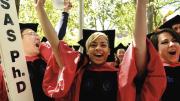 Displaying Ph.D.-powered pride are crimson-gowned Jin Cheng &ldquo;George&rdquo; Ye, Anouska Bhattacharyya, and Cammi Valdez.