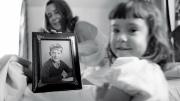 Eve, foreground, and her grandmother, with a fifth-grade photo of Geoffrey