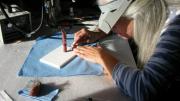 Preservation specialist and glass worker Elizabeth Brill cleaned the models and reattached pieces that had fallen off owing to glue failure. Here she works on a model of red coral. (MCZ SC5, <i>Corallium rubrum</i>)