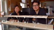 Eric Höweler and Meejin Yoon, with a model of the swings they designed