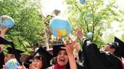 Kennedy School mid-career-degree celebrants (from left) Tadahiro Ikemoto, M.P.H. &rsquo;14, M.P.A. &rsquo;15, of Japan, Zhuldyz Bakytzhanova, M.P.A. &rsquo;15, Sahar Albazar, M.P.A. &rsquo;15, of Egypt, and Alvaro Henzler, M.P.A. &rsquo;15, of Peru