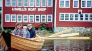 Graham McKay (front) with Jim Heller and Justin Kennick launching one of the shop's boats on the Merrimack River