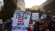 A protester holding a sign that reads "ELECTORAL COLLEGE = VOTER SUPPRESSION" on November 13, 2016.
