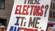Protestors with a large poster demanding reform of the Electoral College