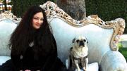 Author Gabrielle Zevin seated on a sofa in Los Angeles with her dog Nico