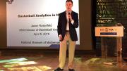 Jason Rosenfeld delivers a presentation with microphone in hand